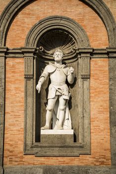 Statue of king Charles V in a niche of the wall of the Royal Palace of Naples, Italy