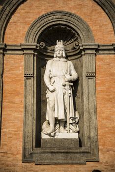 Statue of king Frederick II in a niche of the wall of the Royal Palace of Naples, Italy