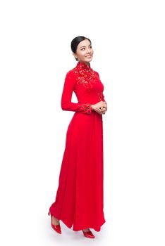 Full body of charming Vietnamese Woman in Ao Dai Traditional Dress isolated on white.