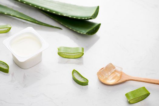 Aloe vera yogurt with fresh leaves on a wooden table