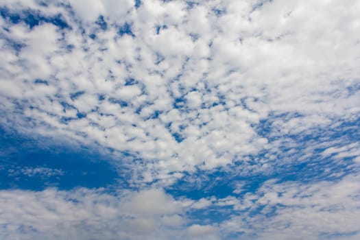 Blue sky background with white clouds. The vast blue sky and clouds sky on sunny day. White fluffy clouds in the blue sky.