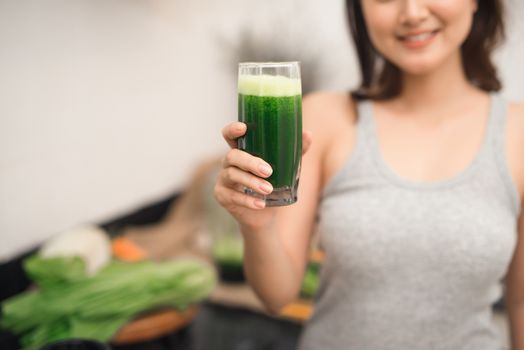 Young asian woman enjoy healthy vegetarian smoothie for weight loss and detox