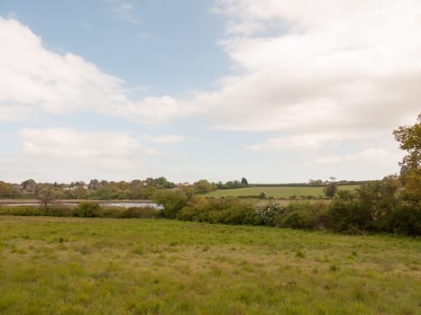 blue and cloudy countryside scene outside in an open field