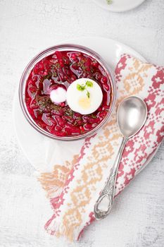 Bowl of beetroot soup with sour cream and eggs.