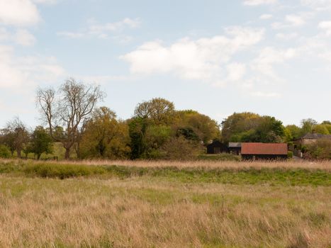 a countryside scene with a barn outside in the spring