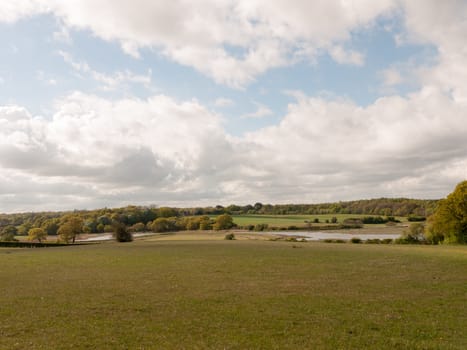 open countryside empty grassland with cloudy blue sky