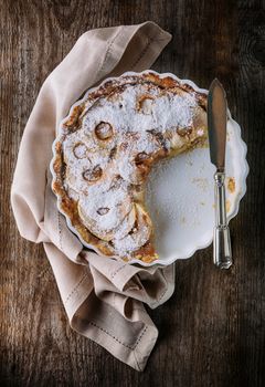 A slice of Apple pie on wooden table