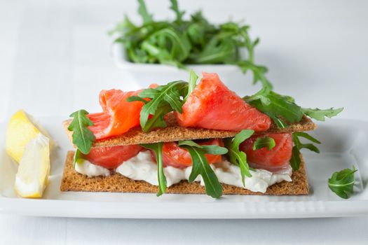 Smoked Salmon on a Healthy Crispbread with Cream Cheese, Fresh Arugula 
