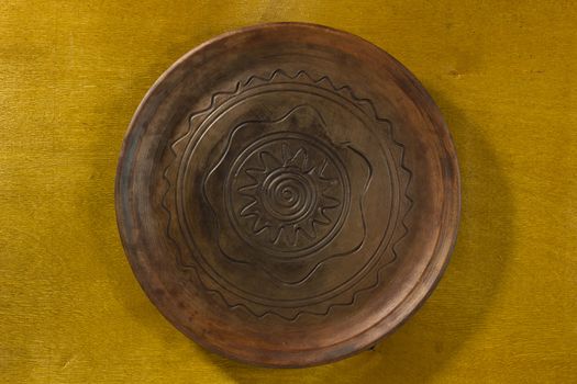 Clay dish with a pattern on a wooden table