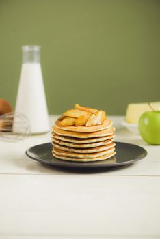 Pancakes with apple on table. Breakfast, snacks. Pancakes Day.