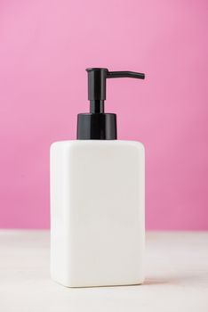 Spa composition with shampoo bottle on white.
