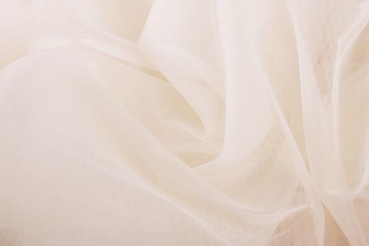ivory chiffon tulle fabric textured background. pleated skirt fabric texture. closeup plisse fabric texture pattern