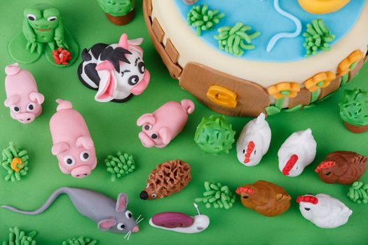 detail of birthday cake with farm marzipan animals and number 3