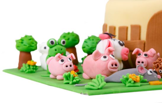 birthday cake with farm marzipan animals and number 3 isolated on white background