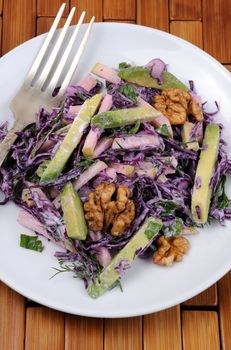 salad  red coleslaw with slices of avocado, apple, nuts, parsley, dill seasoned yoghurt sauce
