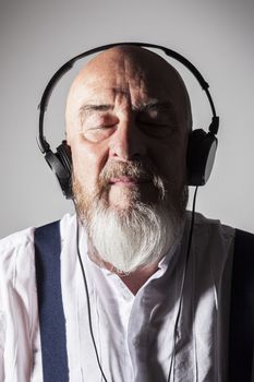 An image of an old man listening to music