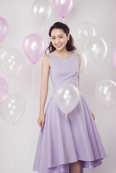 Asian pretty fashionable woman with pastel balloons