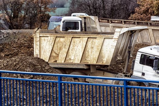 Truck on a construction site during transport of excavated earth.