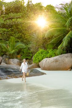 Beautiful woman enjoying the beautiful beachs of Praslin, Seychelles