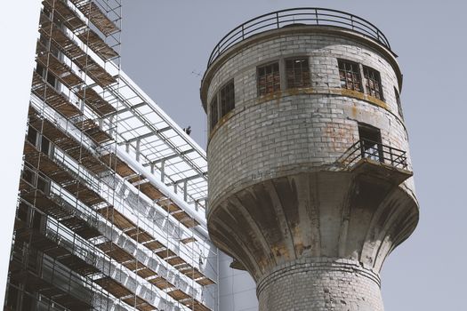 water tower next to a building under construction.