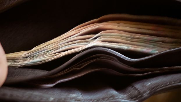 Open wallet with a little paper money.