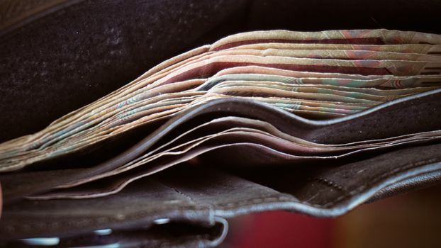 Open wallet with a little paper money.