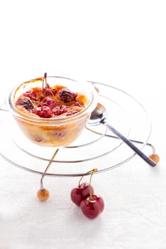 A desert of Clafoutis with cherry on a white background.