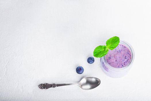 Delicious blueberry yoghurt smoothie with a spoon