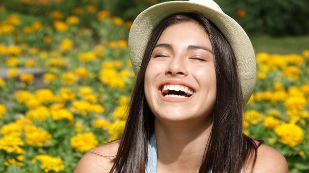 Laughing Teen Girl In Field Of Flowers
