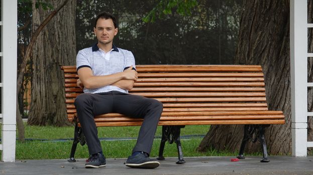 Man Sitting Alone On Park Bench