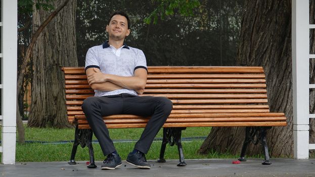 Happy Man Sitting On Park Bench