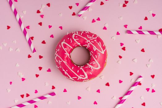 Donuts with icing on pastel pink background with copyspace. Sweet donuts.