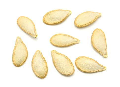 Top view of dried pumpkin seeds on a white background