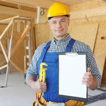 Workman with adjustable wrench and folder with blank document