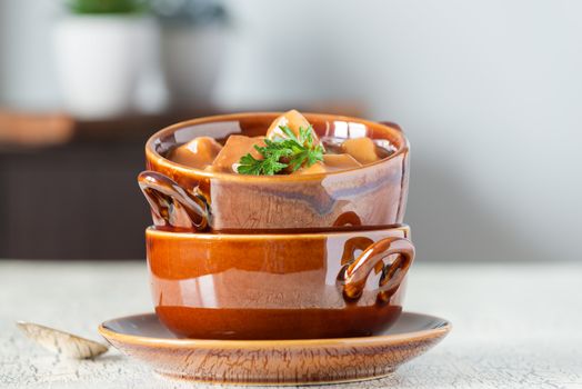 Bowl of hot homemade soup made with pepper steak, mushrooms and potato.