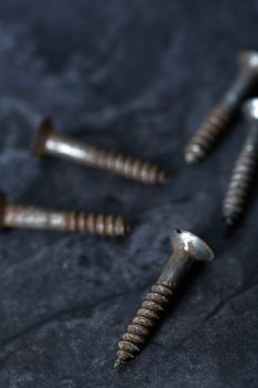 Group of rusty screws. Close-up vertical photo