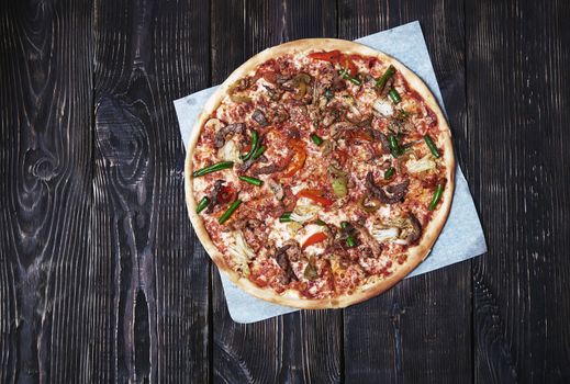 Homemade pizza on a wooden table