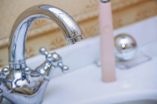 Close-up photo of the chrome water tap and sink