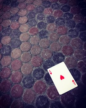 Ace of hearts card on the dirty floor. Good luck concept.