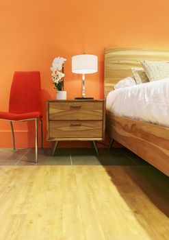 Bright bedroom in orange tones. Contemporary home decor.