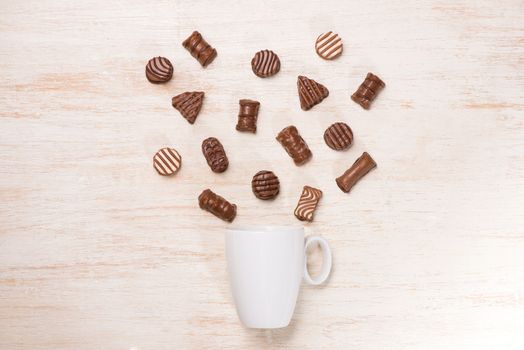 Glass of chocolate milk and variety chocolates  on table