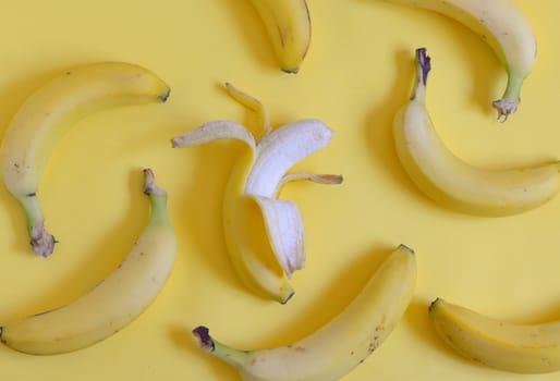 Ripe bananas set on yellow background