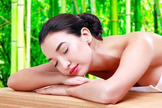 Young beautiful asian woman relaxing at spa salon in bamboo forest, isolated on white background