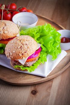 Cheeseburger with salad, onion, tomato and fresh bread