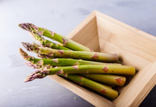 A bunch of fresh green Asparagus on a white surface