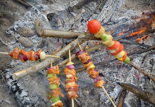 Stick of barbeque roasting in fire