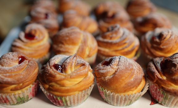 Muffins with jam fresh pastry on baking sheet