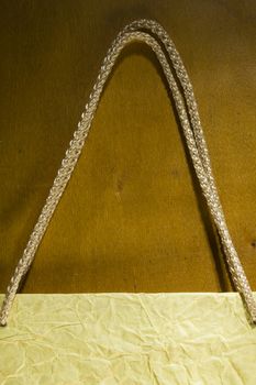 Rope handles from a paper bag on a wooden background