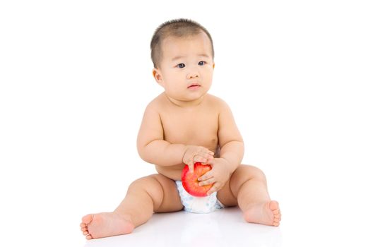 cute asian baby sitting on the floor isolated on white background