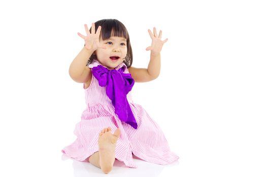 Cute asian girl sitting on the floor and smiling